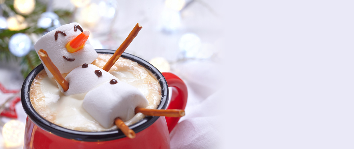 Marshmallow character relaxing in hot cocoa cup.