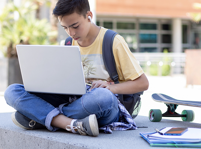 Boy with laptop at school
